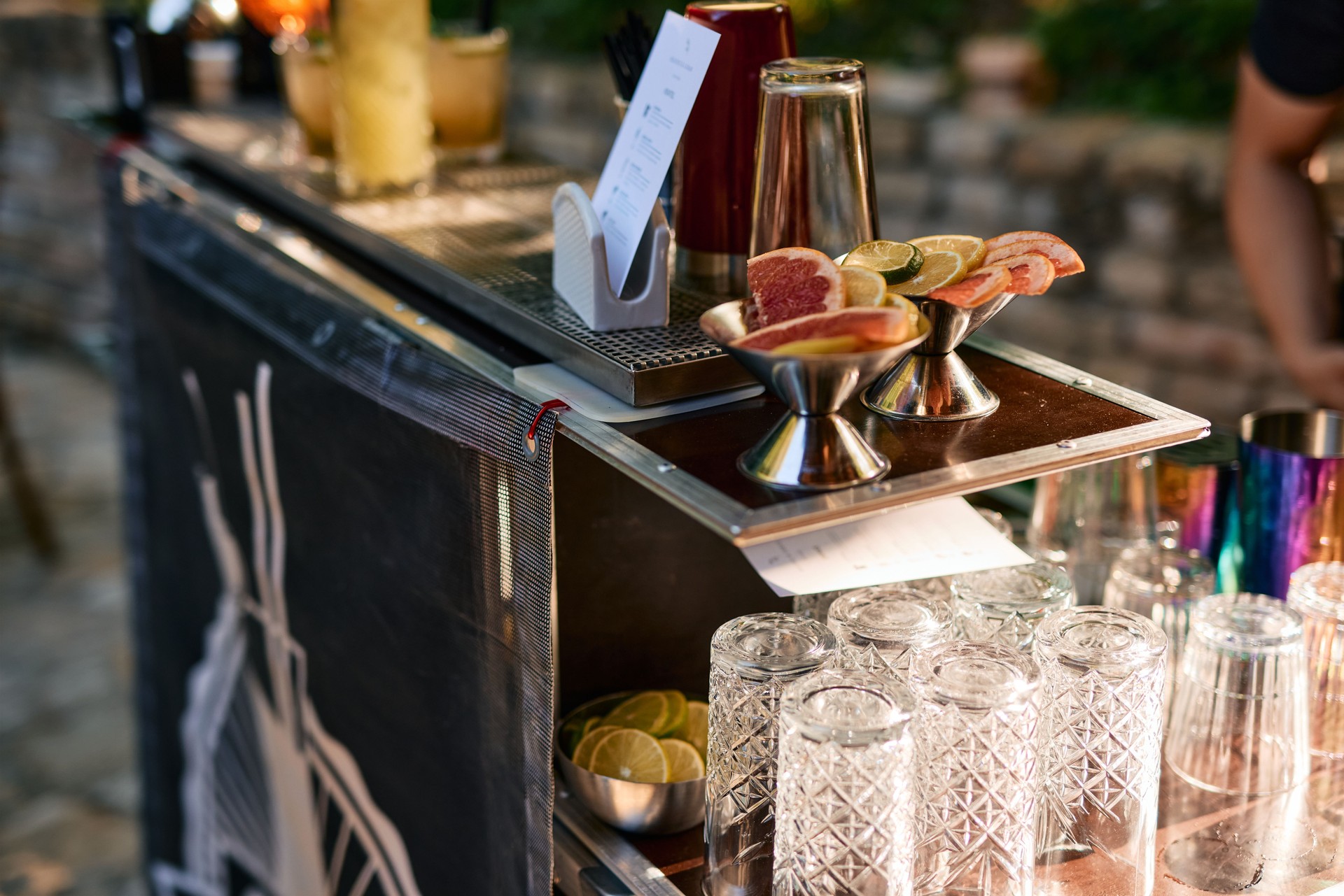 Bartender preparing a mobile cocktail bar for an outdoor event